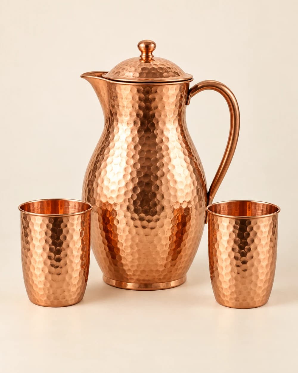 Hammered copper water jug with two glasses